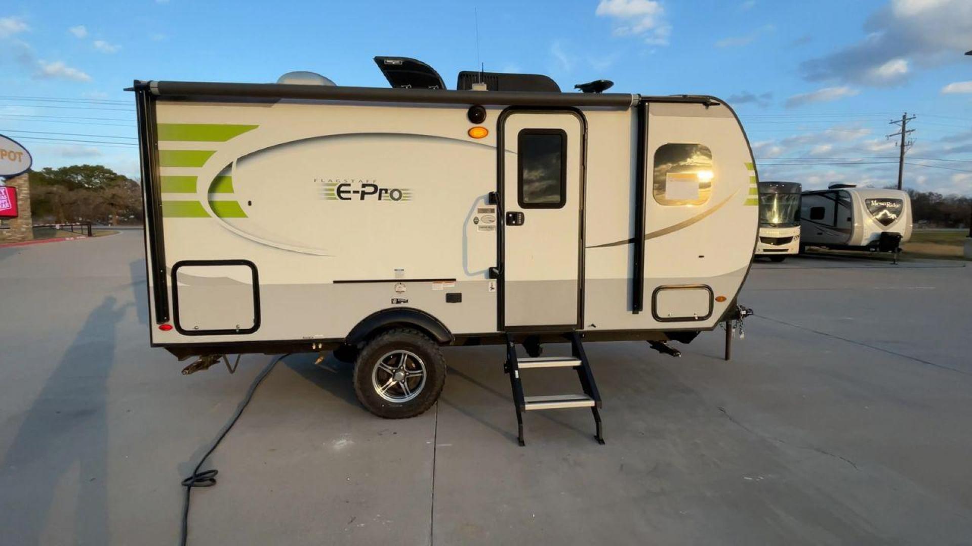 2019 FOREST RIVER FLAGSTAFF E-PRO 16BH (5ZT2FSEC3K3) , Length: 18.33 ft. | Dry Weight: 2,993 lbs. | Slides: 1 transmission, located at 4319 N Main Street, Cleburne, TX, 76033, (817) 221-0660, 32.435829, -97.384178 - The 2019 Forest River Flagstaff E-Pro 16BH is a compact, lightweight travel trailer designed for adventure. Its exterior features a sleek and modern design with a white body accented by bold green graphics, giving it a fresh and sporty look. The single slide-out on the driver's side provides additio - Photo#2