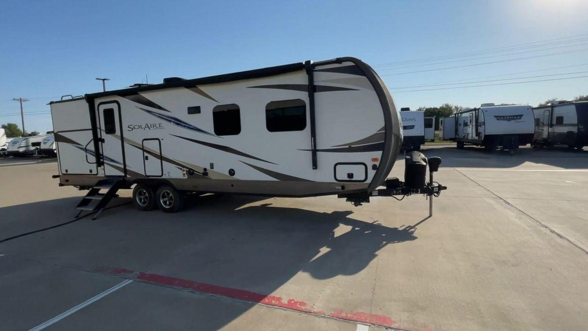 2019 TAN FOREST RIVER SOLAIRE 258RBSS (4X4TPAB24KN) , Length: 32.67 ft. | Dry Weight: 6,398 lbs. | Gross Weight: 7,765 lbs. | Slides: 1 transmission, located at 4319 N Main Street, Cleburne, TX, 76033, (817) 221-0660, 32.435829, -97.384178 - The 2019 Palomino Solaire 258RBSS Travel Trailer combines style with functionality. Measuring 32.67 feet in length, this unit features a single slide-out, which provides additional interior space. The white and gray body is accented with dynamic graphics, offering a contemporary look. The front show - Photo#3