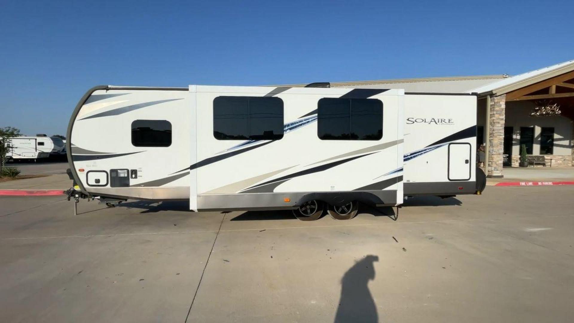 2019 TAN FOREST RIVER SOLAIRE 258RBSS (4X4TPAB24KN) , Length: 32.67 ft. | Dry Weight: 6,398 lbs. | Gross Weight: 7,765 lbs. | Slides: 1 transmission, located at 4319 N Main Street, Cleburne, TX, 76033, (817) 221-0660, 32.435829, -97.384178 - The 2019 Palomino Solaire 258RBSS Travel Trailer combines style with functionality. Measuring 32.67 feet in length, this unit features a single slide-out, which provides additional interior space. The white and gray body is accented with dynamic graphics, offering a contemporary look. The front show - Photo#6