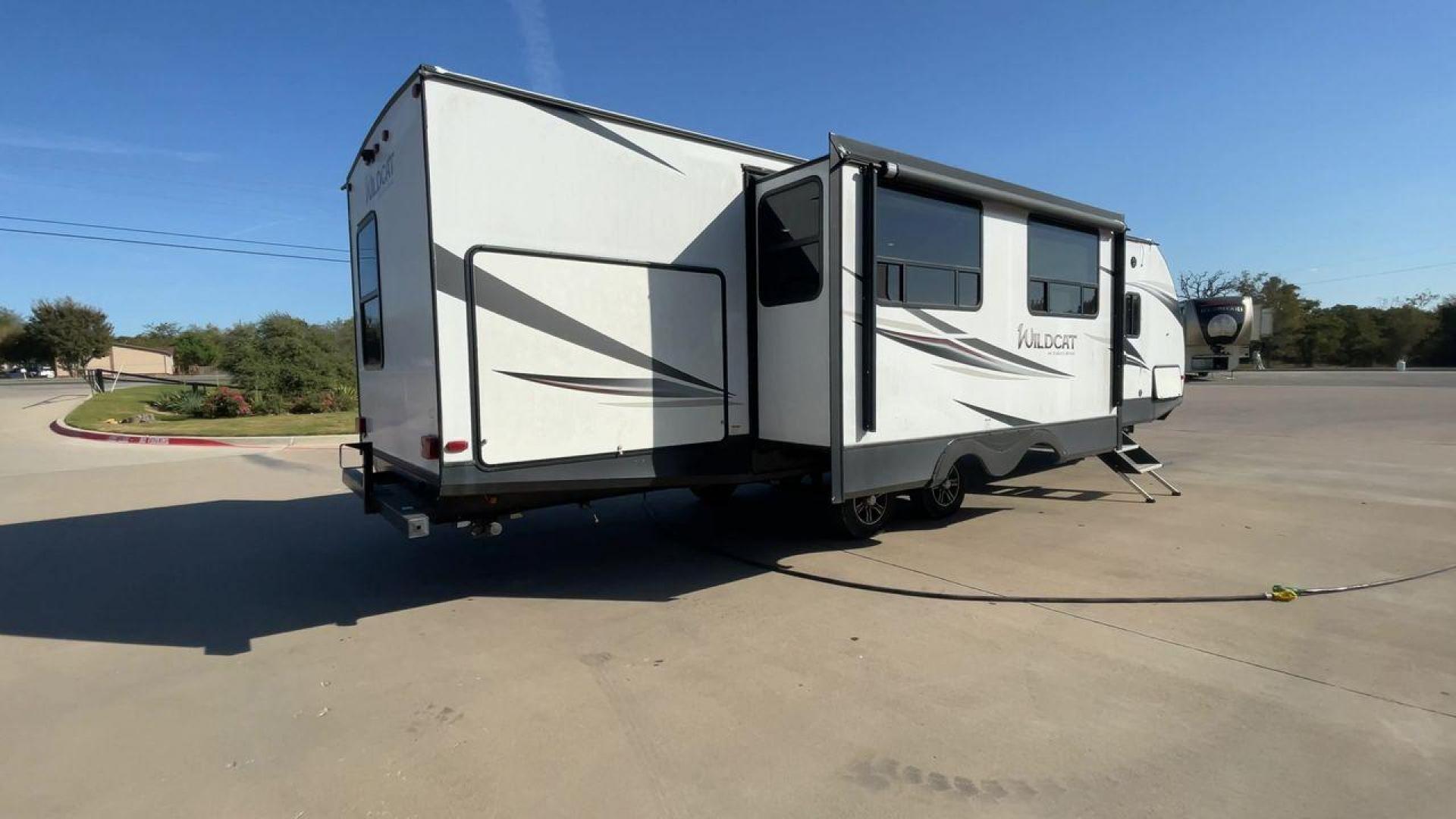 2019 WHITE FOREST RIVER WILDCAT 343BIK (5ZT2WCZB1KB) , Length: 37.42 ft. | Dry Weight: 8,226 lbs. | Slides: 3 transmission, located at 4319 N Main Street, Cleburne, TX, 76033, (817) 221-0660, 32.435829, -97.384178 - The 2019 Forest River Wildcat 343BIK is a triple slide travel trailer that measures 37.42 ft. in length. It has a dry weight of 8,226 lbs. and a payload capacity of 3,002 lbs. It is made of aluminum and fiberglass. It comes with automatic heating and cooling rated at 30,000 and 15,000 BTUs respectiv - Photo#1