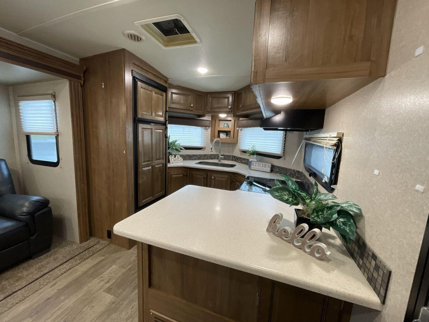 2019 FOREST RIVER WINDJAMMER 3008V (4X4TRLF24K1) , Length: 34 ft | Dry Weight: 7,433 lbs | Slides: 2 transmission, located at 4319 N Main Street, Cleburne, TX, 76033, (817) 221-0660, 32.435829, -97.384178 - Measuring 34 ft long, the 2019 Forest River Windjammer 3008V travel trailer is sleek and modern. The body features a white fiberglass surface accented with brown and black decals that provide a stylish and aerodynamic look. The front of the trailer is distinct with its pointed V-nose design. This en - Photo#9