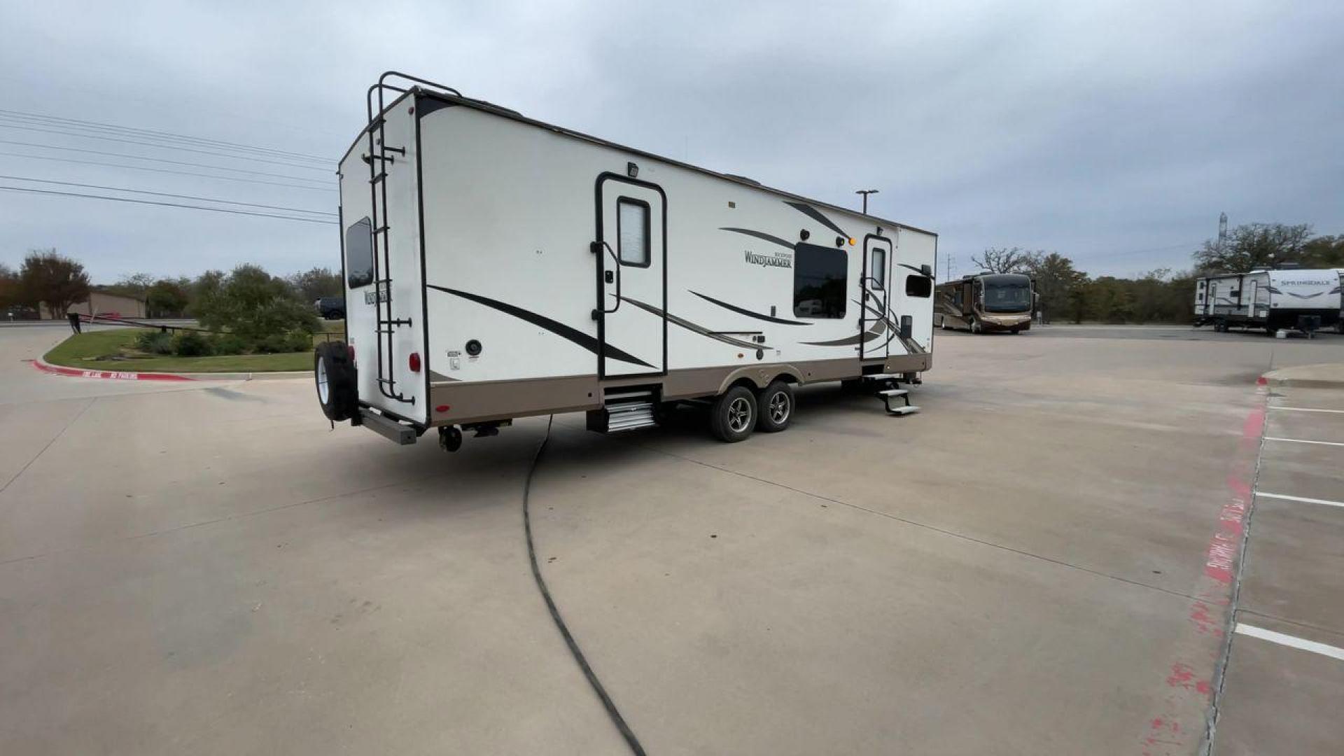 2019 FOREST RIVER WINDJAMMER 3008V (4X4TRLF24K1) , Length: 34 ft | Dry Weight: 7,433 lbs | Slides: 2 transmission, located at 4319 N Main Street, Cleburne, TX, 76033, (817) 221-0660, 32.435829, -97.384178 - Measuring 34 ft long, the 2019 Forest River Windjammer 3008V travel trailer is sleek and modern. The body features a white fiberglass surface accented with brown and black decals that provide a stylish and aerodynamic look. The front of the trailer is distinct with its pointed V-nose design. This en - Photo#1