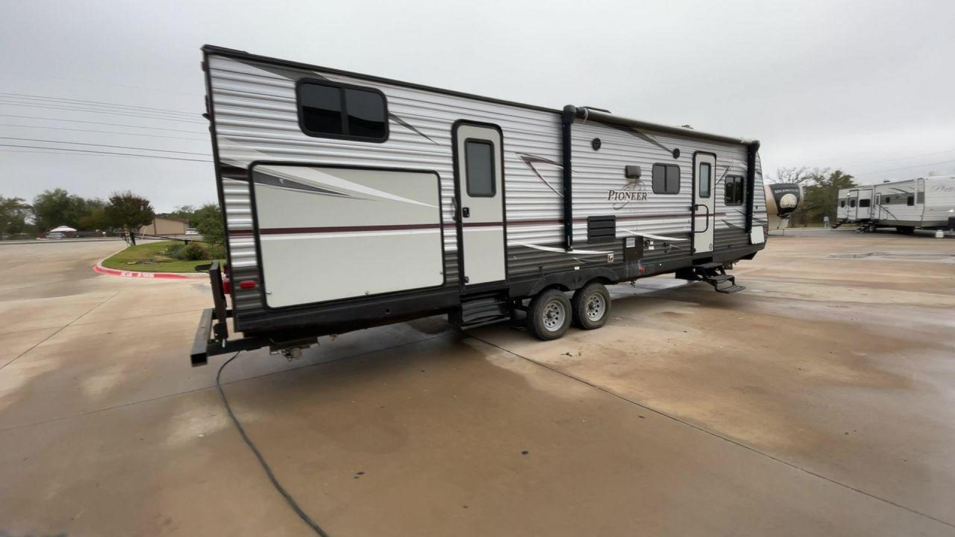 2019 GRAY HEARTLAND PIONEER DS320 (5SFPB3723KE) , Length: 37 ft. | Dry Weight: 7,612 lbs. | Slides: 2 transmission, located at 4319 N Main Street, Cleburne, TX, 76033, (817) 221-0660, 32.435829, -97.384178 - The 2019 Heartland Pioneer DS320 is designed to provide comfort and practicality for adventurers. Measuring 37 feet in length, this RV offers ample space for families or groups. Its dry weight of 7,612 lbs makes it towable by a variety of vehicles while maintaining stability on the road. This unit f - Photo#1