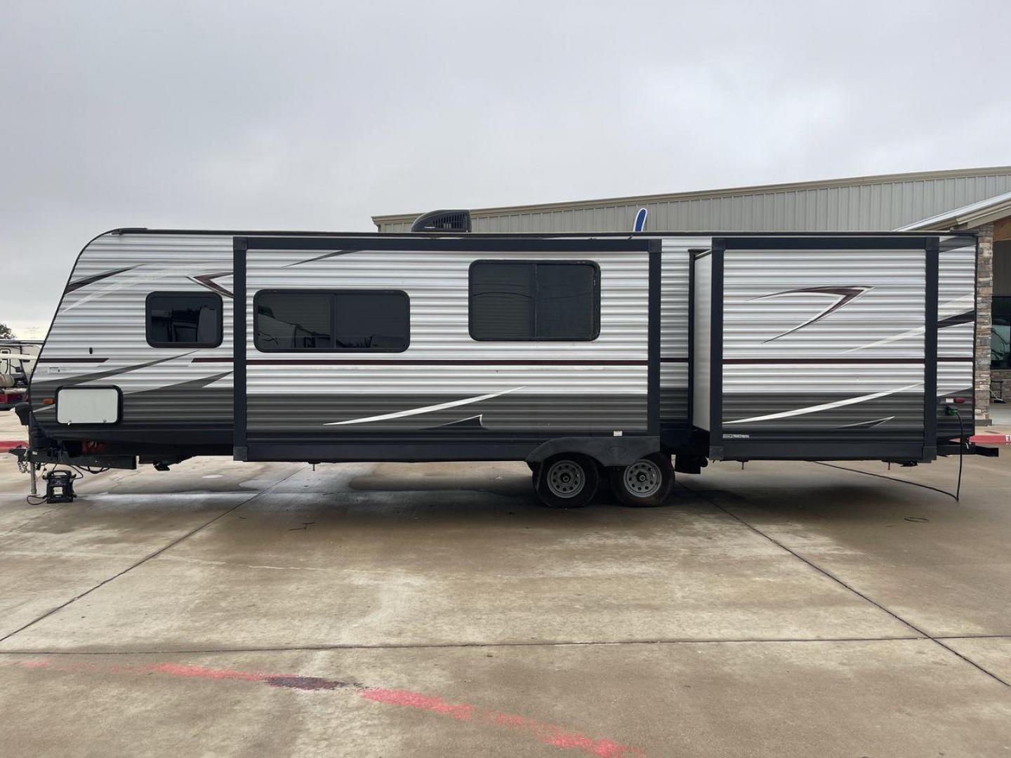 2019 GRAY HEARTLAND PIONEER DS320 (5SFPB3723KE) , Length: 37 ft. | Dry Weight: 7,612 lbs. | Slides: 2 transmission, located at 4319 N Main Street, Cleburne, TX, 76033, (817) 221-0660, 32.435829, -97.384178 - The 2019 Heartland Pioneer DS320 is designed to provide comfort and practicality for adventurers. Measuring 37 feet in length, this RV offers ample space for families or groups. Its dry weight of 7,612 lbs makes it towable by a variety of vehicles while maintaining stability on the road. This unit f - Photo#25