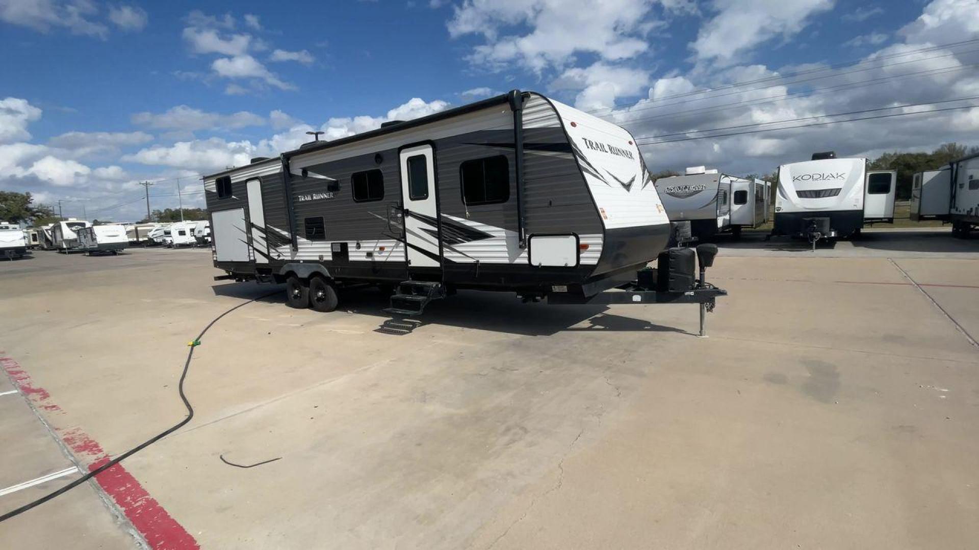 2019 HEARTLAND TRAIL RUNNER 325ODK (5SFEB3624KE) , Length: 36.3 ft. | Dry Weight: 7,724 lbs. | Slides: 2 transmission, located at 4319 N Main Street, Cleburne, TX, 76033, (817) 221-0660, 32.435829, -97.384178 - The 2019 Heartland Trail Runner 325ODK is a spacious travel trailer built for family comfort, with a unique bunkhouse, roomy living area, and outdoor kitchen. This model is perfect for families who enjoy extended trips with the convenience of home-like amenities. The dimensions of this unit are 36.3 - Photo#3