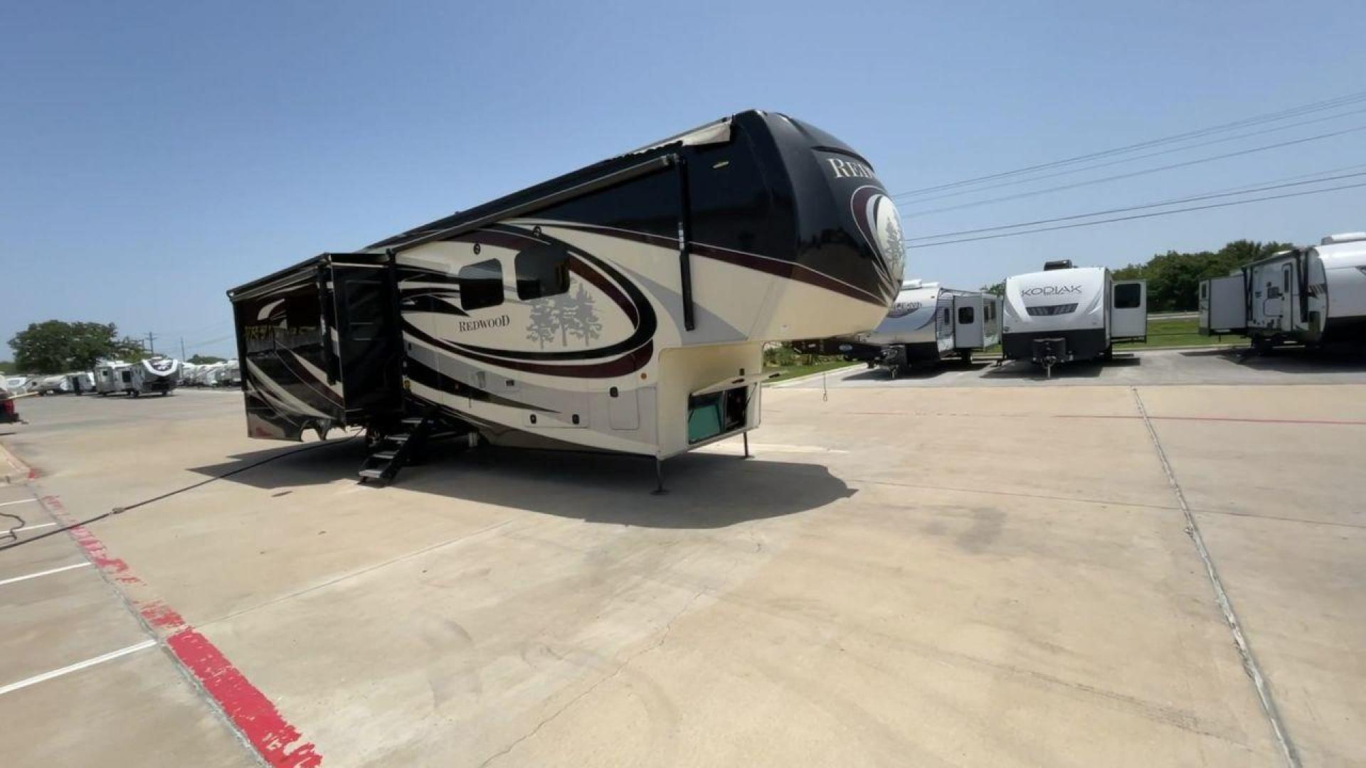 2019 KEYSTONE REDWOOD 3901WB (4YDF39023K9) , Length: 40.17 ft. | Dry Weight: 14,312 lbs. | Slides: 3 transmission, located at 4319 N Main Street, Cleburne, TX, 76033, (817) 221-0660, 32.435829, -97.384178 - The 2019 Keystone Redwood 3901WB is a high-end fifth-wheel RV that blends luxury living with home-like comfort. It's perfect for long trips or full-time living. Its outside has a high-gloss paint job in black and white colors, with the Redwood tree graphics that make it stand out. This RV is over 40 - Photo#2