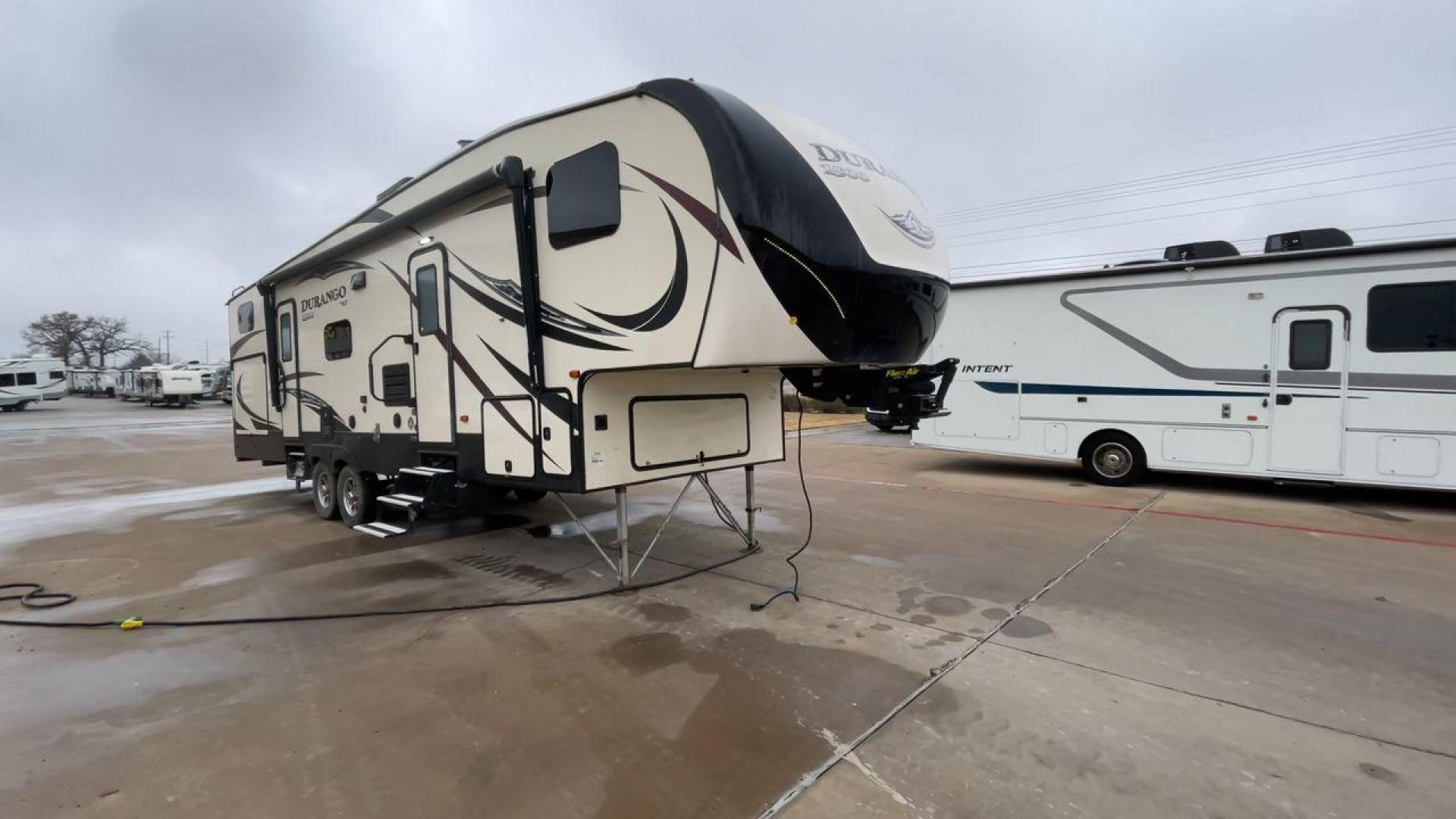 2019 KZ DURANGO GOLD 292BHT (4EZFD2925K6) , Length: 35 ft | Gross Weight: 11,500 lbs | Slides: 3 transmission, located at 4319 N Main Street, Cleburne, TX, 76033, (817) 221-0660, 32.435829, -97.384178 - At 35 ft. long, this 2019 KZ Durango 1500 292BHT fifth wheel RV showcases a striking two-tone cream and black color scheme accented with bold, swooping graphics in shades of gray and burgundy. The front cap features a sleek, aerodynamic design with the "Durango 1500" branding and mountain graphic. A - Photo#3