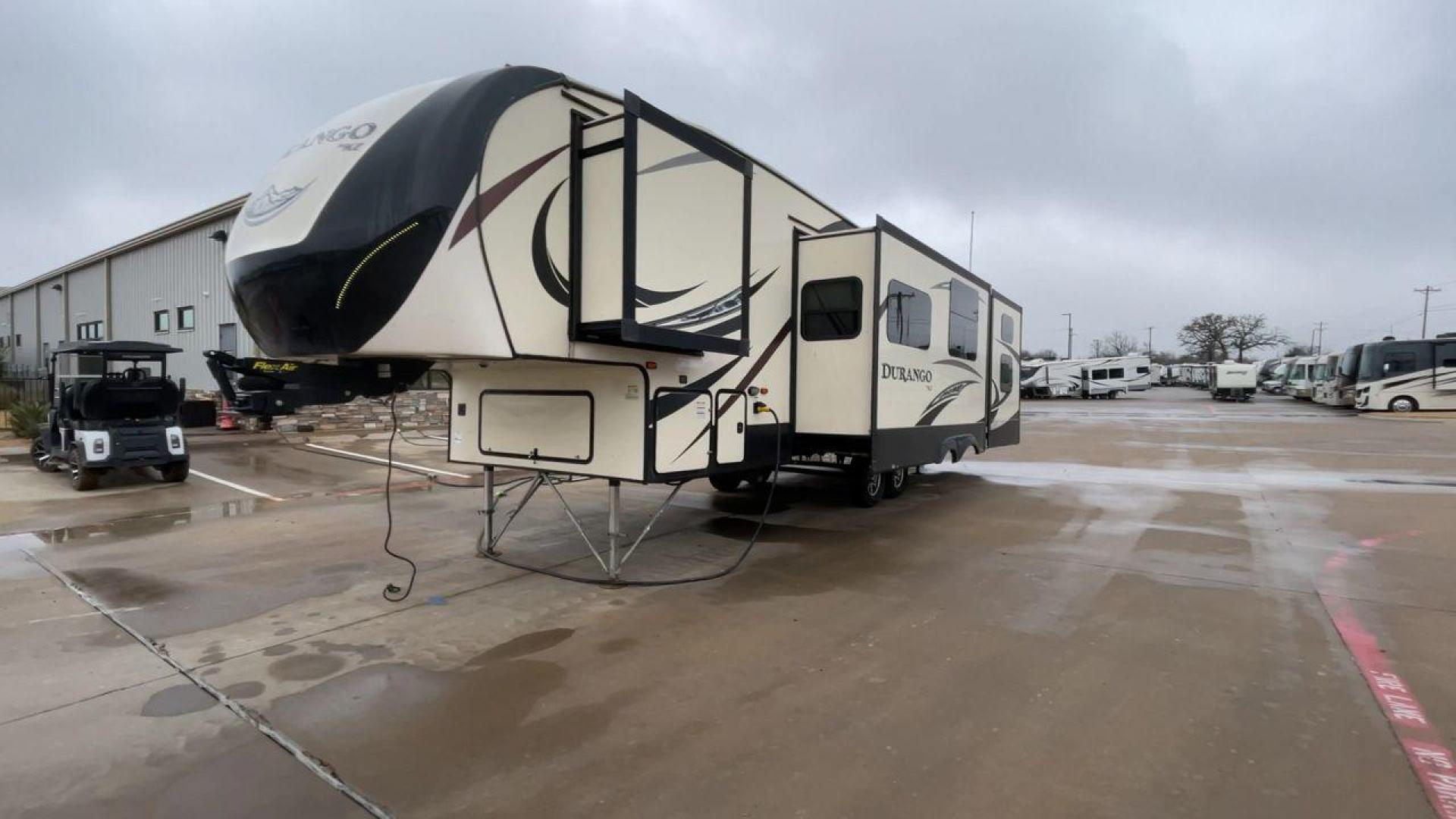 2019 KZ DURANGO GOLD 292BHT (4EZFD2925K6) , Length: 35 ft | Gross Weight: 11,500 lbs | Slides: 3 transmission, located at 4319 N Main Street, Cleburne, TX, 76033, (817) 221-0660, 32.435829, -97.384178 - At 35 ft. long, this 2019 KZ Durango 1500 292BHT fifth wheel RV showcases a striking two-tone cream and black color scheme accented with bold, swooping graphics in shades of gray and burgundy. The front cap features a sleek, aerodynamic design with the "Durango 1500" branding and mountain graphic. A - Photo#5