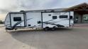 2020 FOREST RIVER FREEDOM EXPRESS (5ZT2FEXBXLW) , Length: 36.92 ft | Dry Weight: 8,328 lbs | Gross Weight: 10,500 lbs | Slides: 3 transmission, located at 4319 N Main Street, Cleburne, TX, 76033, (817) 221-0660, 32.435829, -97.384178 - The 2020 Freedom Express 324RLDS has a white body accented with sleek black and blue graphics, creating a stylish look. The front cap features an aerodynamic shape with bold design lines and a large tinted window. A sturdy electric tongue jack is positioned at the hitch for easy adjustments, complem - Photo#6