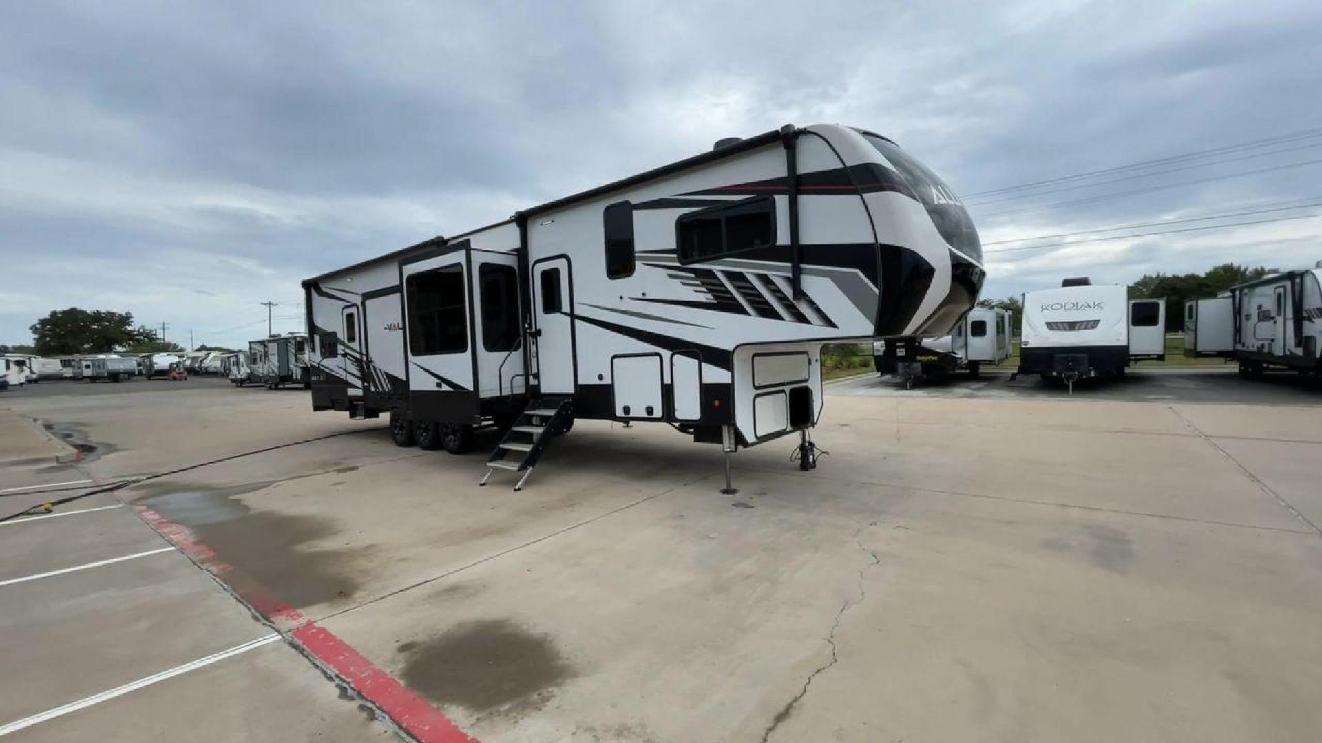 2021 ALLIANCE VALOR 42V13 (7M5FV4533MA) , Length: 44.08 ft. | Dry Weight: 16,064 lbs. | Gross Weight: 20,000 lbs. | Slides: 3 transmission, located at 4319 N Main Street, Cleburne, TX, 76033, (817) 221-0660, 32.435829, -97.384178 - The Valor 42V13 features a striking modern exterior with clean lines, highlighted by its sleek black, white, and gray color scheme. The multiple slide-outs (3) enhance interior space, while the large windows offer plenty of natural light. The rear garage entry has a ramp door for easy loading of rec - Photo#3