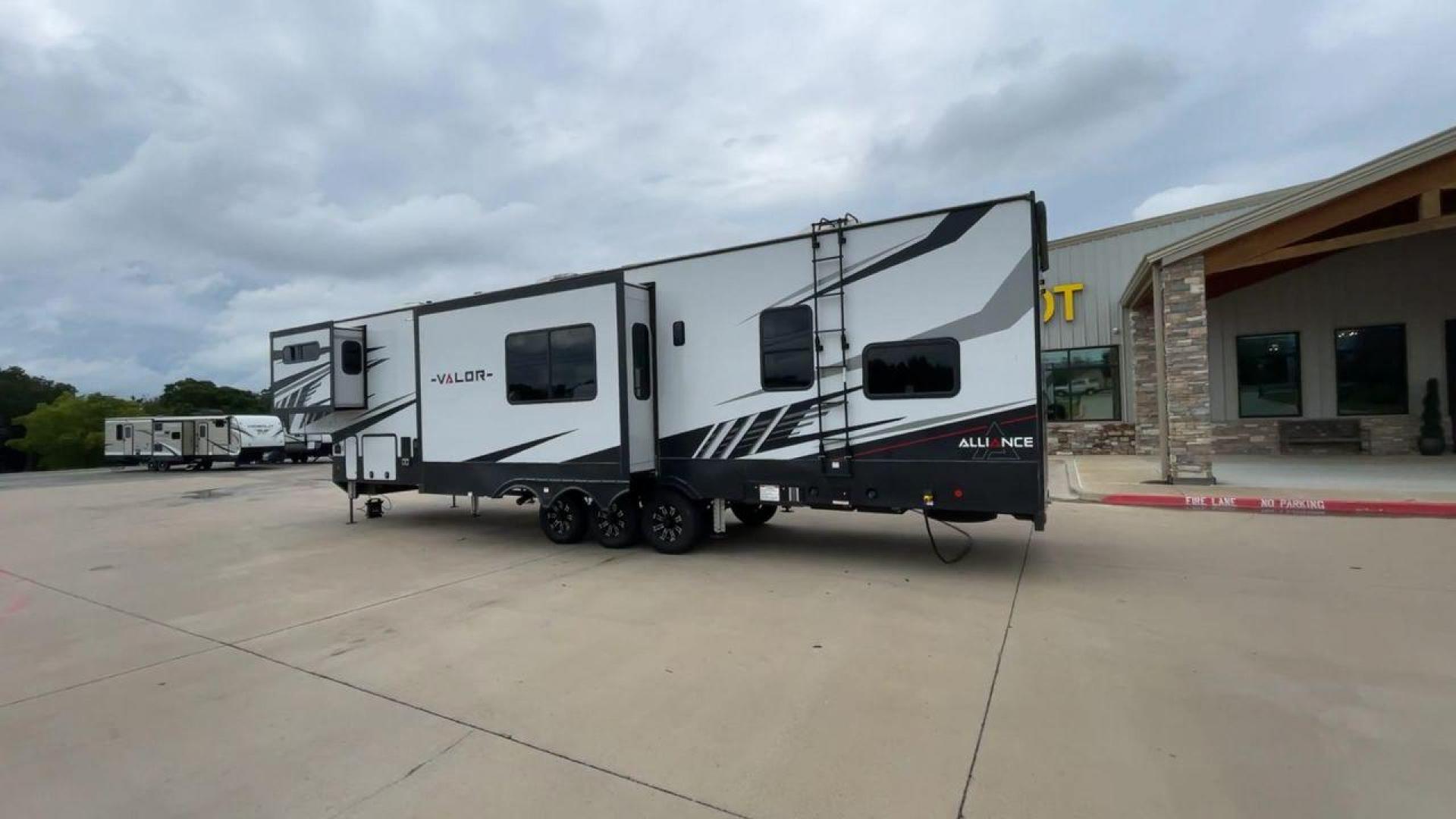 2021 ALLIANCE VALOR 42V13 (7M5FV4533MA) , Length: 44.08 ft. | Dry Weight: 16,064 lbs. | Gross Weight: 20,000 lbs. | Slides: 3 transmission, located at 4319 N Main Street, Cleburne, TX, 76033, (817) 221-0660, 32.435829, -97.384178 - The Valor 42V13 features a striking modern exterior with clean lines, highlighted by its sleek black, white, and gray color scheme. The multiple slide-outs (3) enhance interior space, while the large windows offer plenty of natural light. The rear garage entry has a ramp door for easy loading of rec - Photo#7