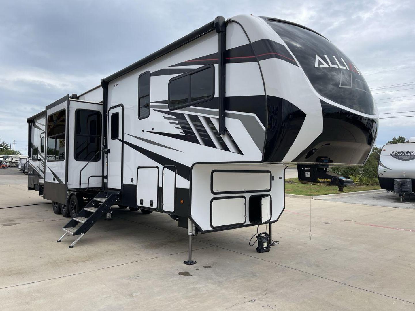 2021 ALLIANCE VALOR 42V13 (7M5FV4533MA) , Length: 44.08 ft. | Dry Weight: 16,064 lbs. | Gross Weight: 20,000 lbs. | Slides: 3 transmission, located at 4319 N Main Street, Cleburne, TX, 76033, (817) 221-0660, 32.435829, -97.384178 - The Valor 42V13 features a striking modern exterior with clean lines, highlighted by its sleek black, white, and gray color scheme. The multiple slide-outs (3) enhance interior space, while the large windows offer plenty of natural light. The rear garage entry has a ramp door for easy loading of rec - Photo#23