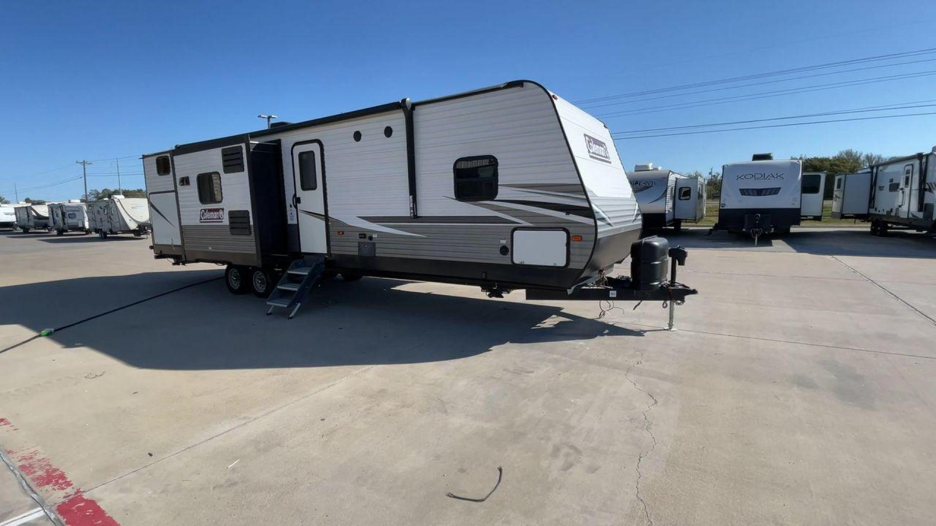 2021 DUTCHMEN COLEMAN 337BH (4YDT33723MH) , Length: 37.92 ft. | Dry Weight: 8,481 lbs. | Slides: 3 transmission, located at 4319 N Main Street, Cleburne, TX, 76033, (817) 221-0660, 32.435829, -97.384178 - The 2021 Dutchmen Coleman 337BH, stretching 37.92 feet in length and weighing 8,481 lbs, showcases a sleek exterior designed for functionality and style. With its gray and black color scheme accented by the Coleman branding, this RV has a sturdy, aerodynamic front and a solid frame for durability. T - Photo#3