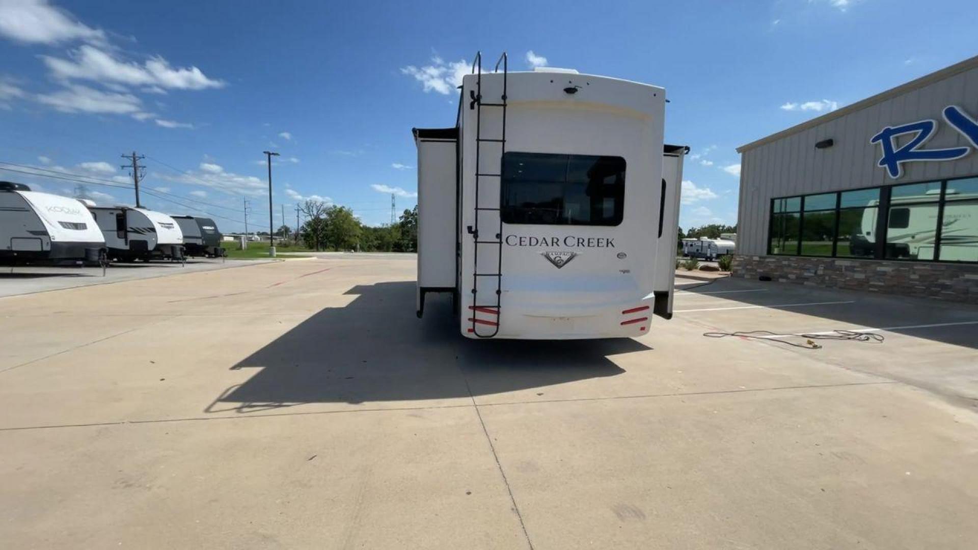 2021 FOREST RIVER CEDAR CREEK 38EL (4X4FCRP25MS) , Length: 39.75 ft. | Dry Weight: 14,429 lbs. | Gross Weight: 18,000 lbs. | Slides: 3 transmission, located at 4319 N Main Street, Cleburne, TX, 76033, (817) 221-0660, 32.435829, -97.384178 - The 2021 Forest River Cedar Creek 38EL Champagne offers luxury and space for your next adventure. With a length of 39.75 feet and a dry weight of 14,429 lbs., this RV boasts three spacious slides to maximize living space. The exterior features sleek lines with large windows and a ladder at the rear, - Photo#8