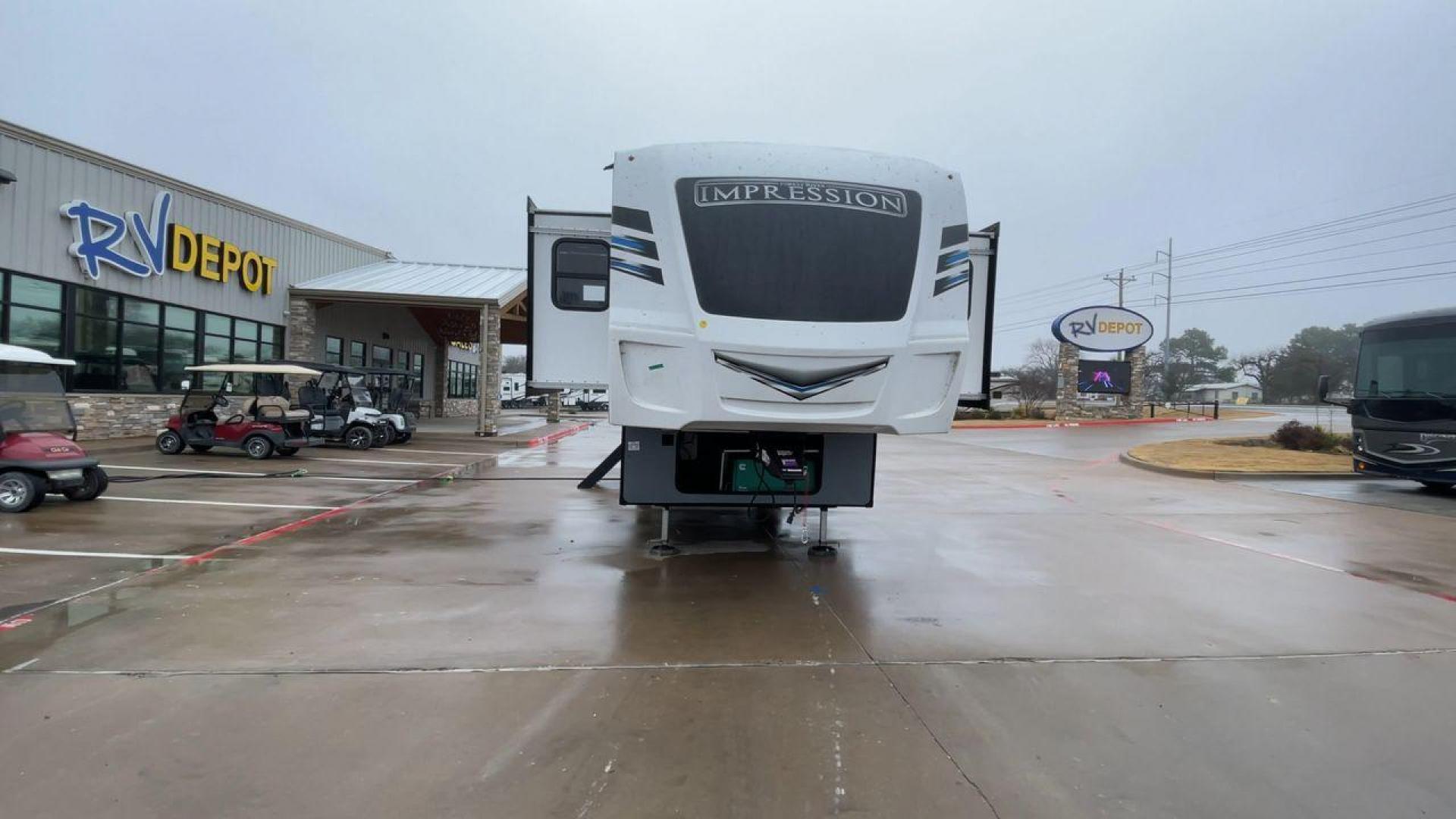 2021 FOREST RIVER IMPRESSION 320FL (5ZT3MPXB1MD) , Length: 40.17 ft | Dry Weight: 10,303 lbs | Gross Weight: 14,535 lbs | Slides: 4 transmission, located at 4319 N Main Street, Cleburne, TX, 76033, (817) 221-0660, 32.435829, -97.384178 - The 2021 Forest River Impression 320FL fifth wheel RV is built for durability and style. Its sleek white fiberglass body is accented with bold black and blue graphics, giving it a modern and aerodynamic look. The front cap features a distinctive aerodynamic profile with the Impression logo prominent - Photo#4