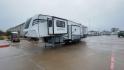 2021 FOREST RIVER IMPRESSION 320FL (5ZT3MPXB1MD) , Length: 40.17 ft | Dry Weight: 10,303 lbs | Gross Weight: 14,535 lbs | Slides: 4 transmission, located at 4319 N Main Street, Cleburne, TX, 76033, (817) 221-0660, 32.435829, -97.384178 - The 2021 Forest River Impression 320FL fifth wheel RV is built for durability and style. Its sleek white fiberglass body is accented with bold black and blue graphics, giving it a modern and aerodynamic look. The front cap features a distinctive aerodynamic profile with the Impression logo prominent - Photo#5