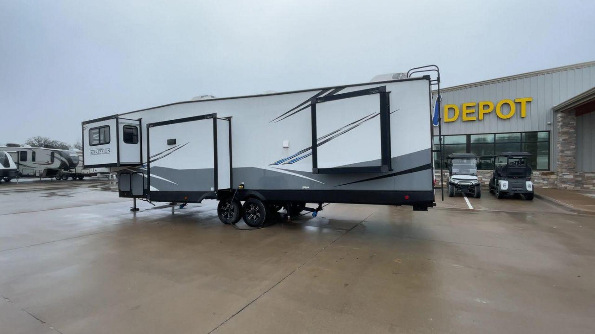 2021 FOREST RIVER IMPRESSION 320FL (5ZT3MPXB1MD) , Length: 40.17 ft | Dry Weight: 10,303 lbs | Gross Weight: 14,535 lbs | Slides: 4 transmission, located at 4319 N Main Street, Cleburne, TX, 76033, (817) 221-0660, 32.435829, -97.384178 - The 2021 Forest River Impression 320FL fifth wheel RV is built for durability and style. Its sleek white fiberglass body is accented with bold black and blue graphics, giving it a modern and aerodynamic look. The front cap features a distinctive aerodynamic profile with the Impression logo prominent - Photo#7