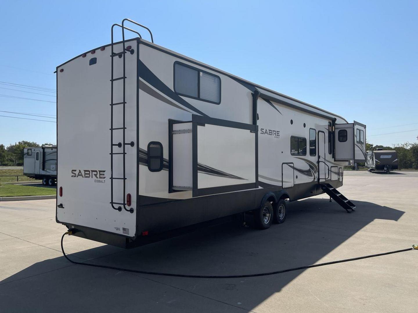 2021 FOREST RIVER SABRE 37FLL (5ZT3SR2B3M6) , Length: 42.75 ft. | Dry Weight: 11,918 lbs. | Slides: 4 transmission, located at 4319 N Main Street, Cleburne, TX, 76033, (817) 221-0660, 32.435829, -97.384178 - The 2021 Forest River Sabre 37FLL is a large, luxurious fifth-wheel trailer that measures 42.75 feet in length and features four slide-outs. It has an aerodynamic front cap with the Sabre Cobalt logo and bold, modern graphics. The curved front end is designed to reduce wind drag when towing. The rea - Photo#25