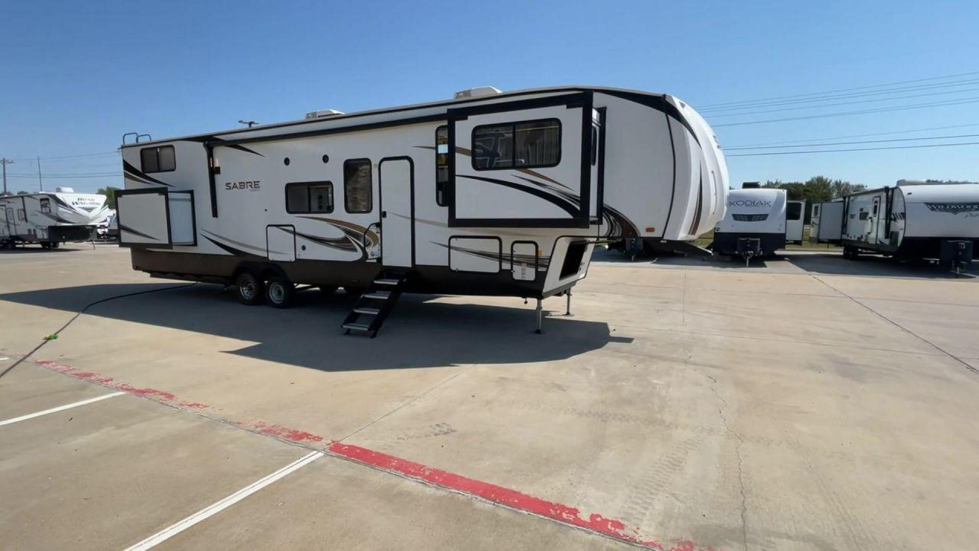 2021 FOREST RIVER SABRE 37FLL (5ZT3SR2B3M6) , Length: 42.75 ft. | Dry Weight: 11,918 lbs. | Slides: 4 transmission, located at 4319 N Main Street, Cleburne, TX, 76033, (817) 221-0660, 32.435829, -97.384178 - The 2021 Forest River Sabre 37FLL is a large, luxurious fifth-wheel trailer that measures 42.75 feet in length and features four slide-outs. It has an aerodynamic front cap with the Sabre Cobalt logo and bold, modern graphics. The curved front end is designed to reduce wind drag when towing. The rea - Photo#3