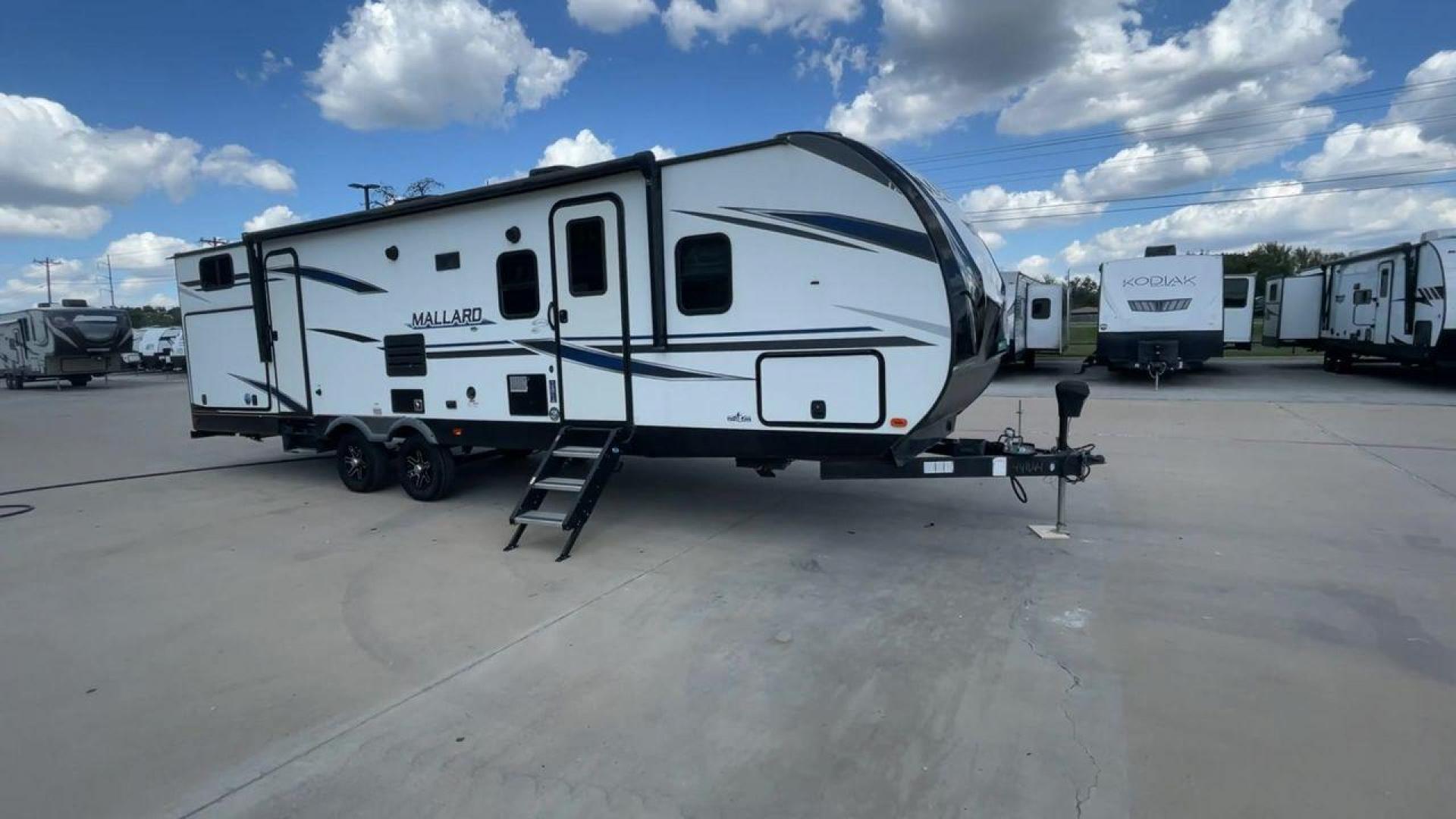 2021 HEARTLAND MALLARD M32 (5SFNB3524ME) , Length: 34.79 ft. | Dry Weight: 6,926 lbs. | Gross Weight: 8,600 lbs. | Slides: 2 transmission, located at 4319 N Main Street, Cleburne, TX, 76033, (817) 221-0660, 32.435829, -97.384178 - The 2021 Heartland Mallard M32 is a sleek and modern travel trailer with a length of 34.79 feet and a dry weight of 6,926 lbs. The gross weight is 8,600 lbs, making it easily towable by larger SUVs and trucks. It features a clean, white exterior with stylish blue and black decals that run along the - Photo#3