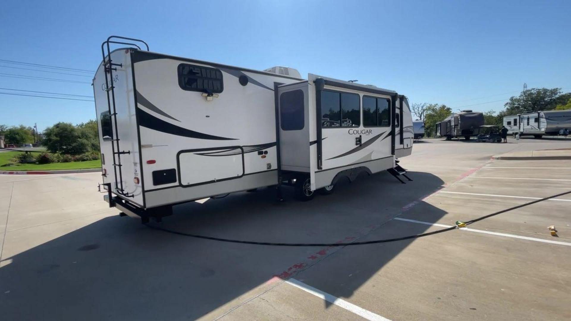 2021 KEYSTONE COUGAR 34TSB (4YDT34T26MV) , Length: 37.42 ft. | Dry Weight: 8,563 lbs. | Gross Weight: 10,500 lbs. | Slides: 3 transmission, located at 4319 N Main Street, Cleburne, TX, 76033, (817) 221-0660, 32.435829, -97.384178 - The 2021 Keystone Cougar 34TSB is a spacious and stylish travel trailer. With a total length of 37.42 feet and a dry weight of 8,563 lbs, it is both manageable for towing and expansive inside. Its sleek white exterior is accented with black and gray details, featuring bold Cougar branding on the fro - Photo#1