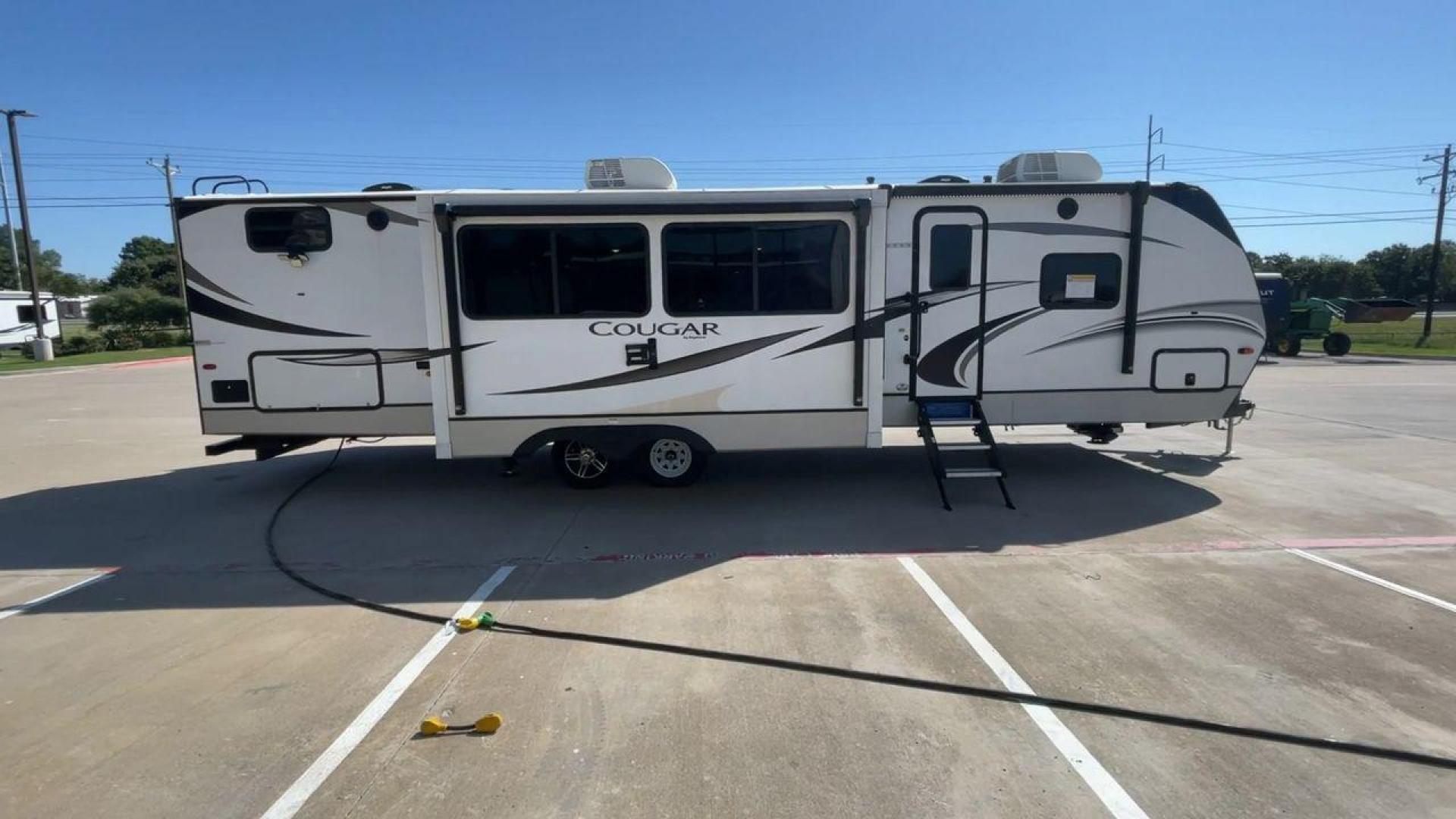 2021 KEYSTONE COUGAR 34TSB (4YDT34T26MV) , Length: 37.42 ft. | Dry Weight: 8,563 lbs. | Gross Weight: 10,500 lbs. | Slides: 3 transmission, located at 4319 N Main Street, Cleburne, TX, 76033, (817) 221-0660, 32.435829, -97.384178 - The 2021 Keystone Cougar 34TSB is a spacious and stylish travel trailer. With a total length of 37.42 feet and a dry weight of 8,563 lbs, it is both manageable for towing and expansive inside. Its sleek white exterior is accented with black and gray details, featuring bold Cougar branding on the fro - Photo#2