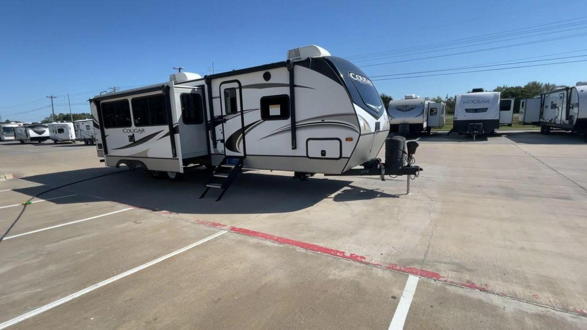 2021 KEYSTONE COUGAR 34TSB (4YDT34T26MV) , Length: 37.42 ft. | Dry Weight: 8,563 lbs. | Gross Weight: 10,500 lbs. | Slides: 3 transmission, located at 4319 N Main Street, Cleburne, TX, 76033, (817) 221-0660, 32.435829, -97.384178 - The 2021 Keystone Cougar 34TSB is a spacious and stylish travel trailer. With a total length of 37.42 feet and a dry weight of 8,563 lbs, it is both manageable for towing and expansive inside. Its sleek white exterior is accented with black and gray details, featuring bold Cougar branding on the fro - Photo#3