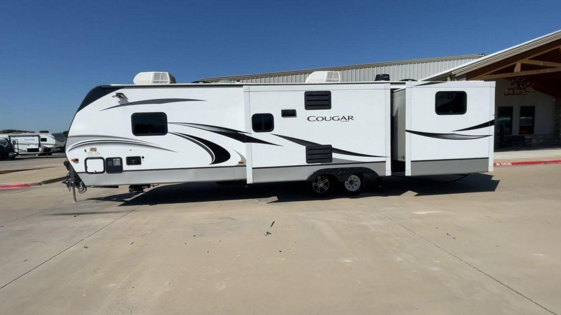 2021 KEYSTONE COUGAR 34TSB (4YDT34T26MV) , Length: 37.42 ft. | Dry Weight: 8,563 lbs. | Gross Weight: 10,500 lbs. | Slides: 3 transmission, located at 4319 N Main Street, Cleburne, TX, 76033, (817) 221-0660, 32.435829, -97.384178 - The 2021 Keystone Cougar 34TSB is a spacious and stylish travel trailer. With a total length of 37.42 feet and a dry weight of 8,563 lbs, it is both manageable for towing and expansive inside. Its sleek white exterior is accented with black and gray details, featuring bold Cougar branding on the fro - Photo#6