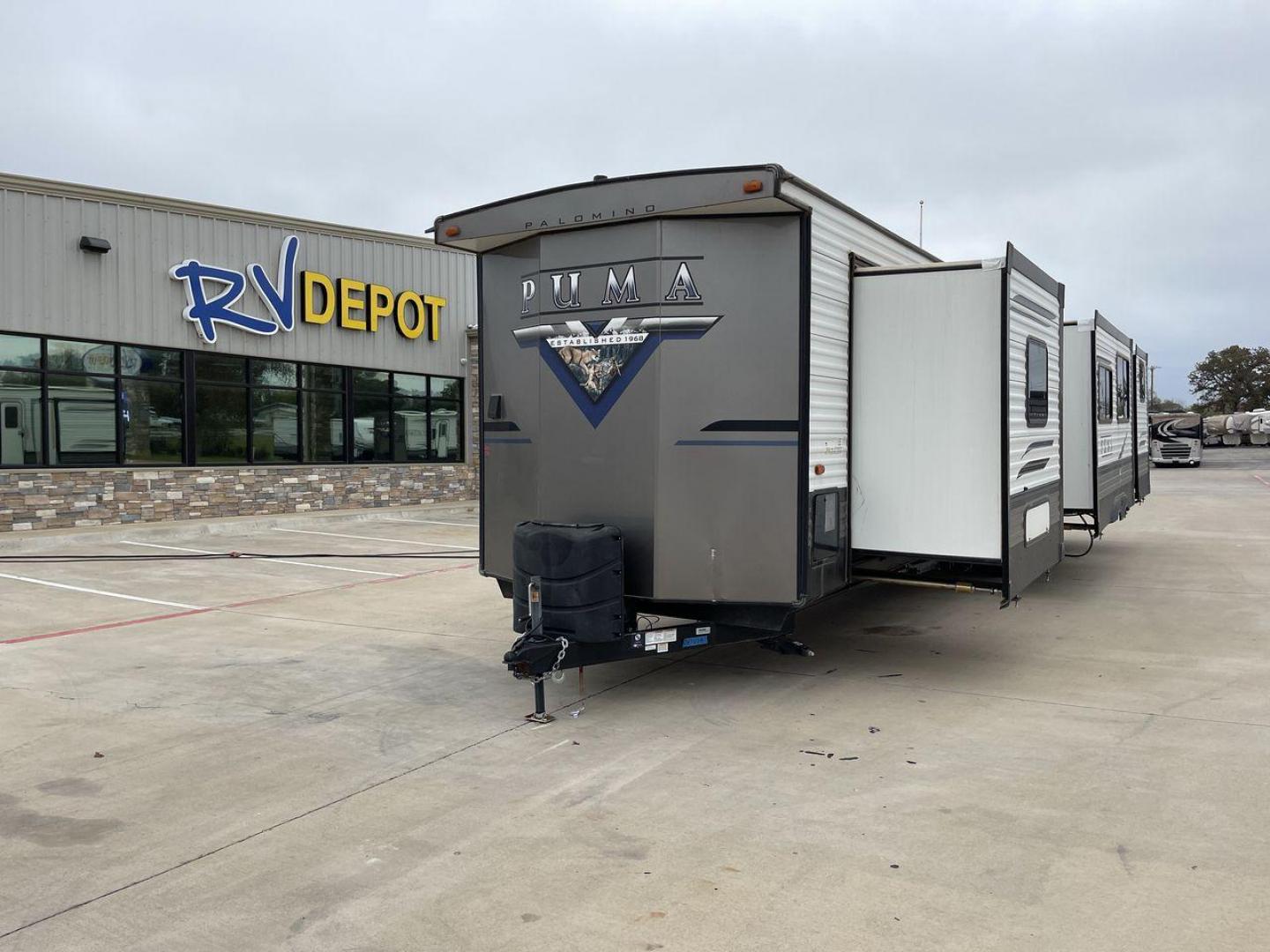 2021 TAN PUMA 39PQB - (4X4TPUR25MP) , located at 4319 N Main Street, Cleburne, TX, 76033, (817) 221-0660, 32.435829, -97.384178 - This Puma Travel Trailer measures just over 42 feet long and 8 feet wide with a dry weight of 10,709 lbs. It has a GVWR of 13,413 lbs and a hitch weight of 1,413 lbs. This unit comes with automatic heating and cooling rated at 35,000 and 13,500 BTUs respectively. The exterior of this unit is a base - Photo#0