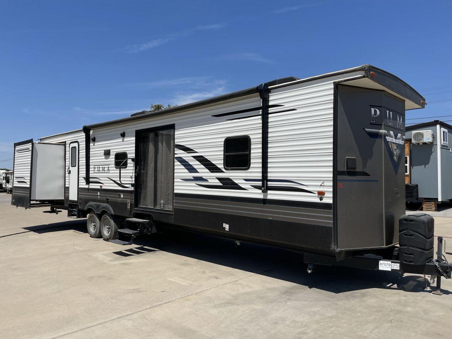 2021 TAN PUMA 39PQB - (4X4TPUR25MP) , located at 4319 N Main Street, Cleburne, TX, 76033, (817) 221-0660, 32.435829, -97.384178 - This Puma Travel Trailer measures just over 42 feet long and 8 feet wide with a dry weight of 10,709 lbs. It has a GVWR of 13,413 lbs and a hitch weight of 1,413 lbs. This unit comes with automatic heating and cooling rated at 35,000 and 13,500 BTUs respectively. The exterior of this unit is a base - Photo#23