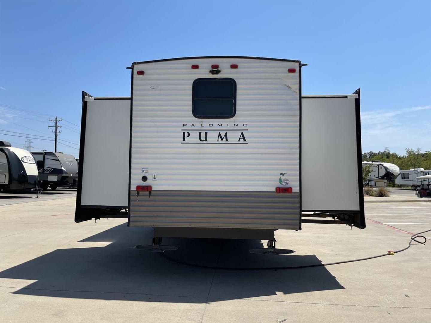 2021 TAN PUMA 39PQB - (4X4TPUR25MP) , located at 4319 N Main Street, Cleburne, TX, 76033, (817) 221-0660, 32.435829, -97.384178 - This Puma Travel Trailer measures just over 42 feet long and 8 feet wide with a dry weight of 10,709 lbs. It has a GVWR of 13,413 lbs and a hitch weight of 1,413 lbs. This unit comes with automatic heating and cooling rated at 35,000 and 13,500 BTUs respectively. The exterior of this unit is a base - Photo#25