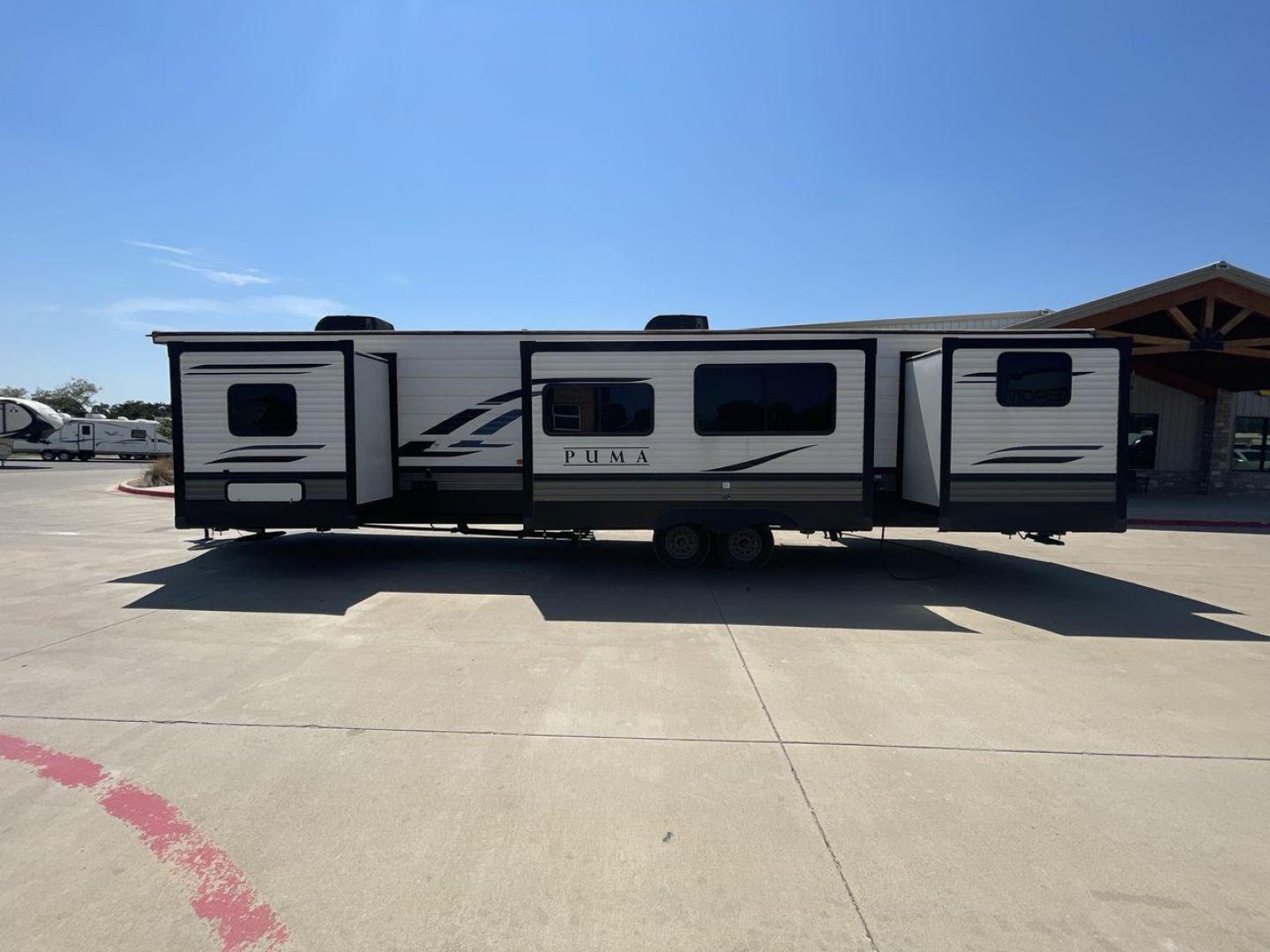 2021 TAN PUMA 39PQB - (4X4TPUR25MP) , located at 4319 N Main Street, Cleburne, TX, 76033, (817) 221-0660, 32.435829, -97.384178 - This Puma Travel Trailer measures just over 42 feet long and 8 feet wide with a dry weight of 10,709 lbs. It has a GVWR of 13,413 lbs and a hitch weight of 1,413 lbs. This unit comes with automatic heating and cooling rated at 35,000 and 13,500 BTUs respectively. The exterior of this unit is a base - Photo#26