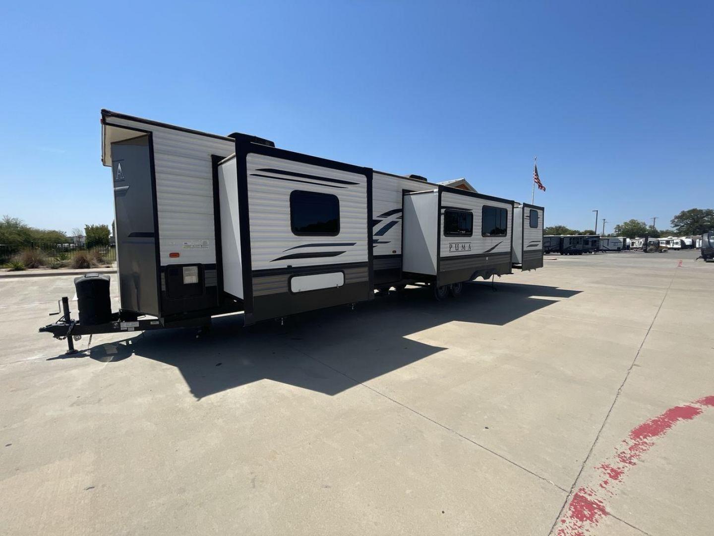 2021 TAN PUMA 39PQB - (4X4TPUR25MP) , located at 4319 N Main Street, Cleburne, TX, 76033, (817) 221-0660, 32.435829, -97.384178 - This Puma Travel Trailer measures just over 42 feet long and 8 feet wide with a dry weight of 10,709 lbs. It has a GVWR of 13,413 lbs and a hitch weight of 1,413 lbs. This unit comes with automatic heating and cooling rated at 35,000 and 13,500 BTUs respectively. The exterior of this unit is a base - Photo#27