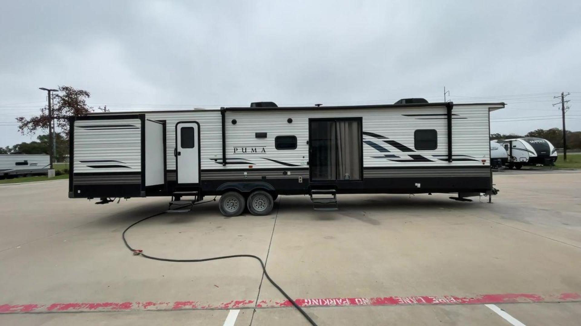 2021 TAN PUMA 39PQB - (4X4TPUR25MP) , located at 4319 N Main Street, Cleburne, TX, 76033, (817) 221-0660, 32.435829, -97.384178 - This Puma Travel Trailer measures just over 42 feet long and 8 feet wide with a dry weight of 10,709 lbs. It has a GVWR of 13,413 lbs and a hitch weight of 1,413 lbs. This unit comes with automatic heating and cooling rated at 35,000 and 13,500 BTUs respectively. The exterior of this unit is a base - Photo#2