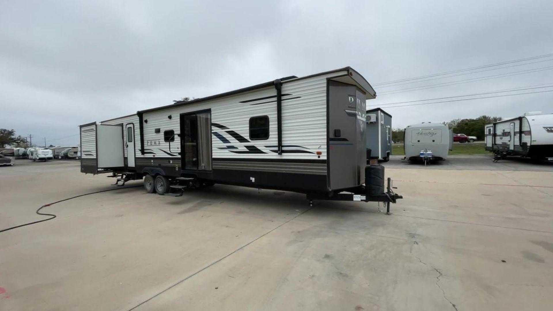 2021 TAN PUMA 39PQB - (4X4TPUR25MP) , located at 4319 N Main Street, Cleburne, TX, 76033, (817) 221-0660, 32.435829, -97.384178 - This Puma Travel Trailer measures just over 42 feet long and 8 feet wide with a dry weight of 10,709 lbs. It has a GVWR of 13,413 lbs and a hitch weight of 1,413 lbs. This unit comes with automatic heating and cooling rated at 35,000 and 13,500 BTUs respectively. The exterior of this unit is a base - Photo#3