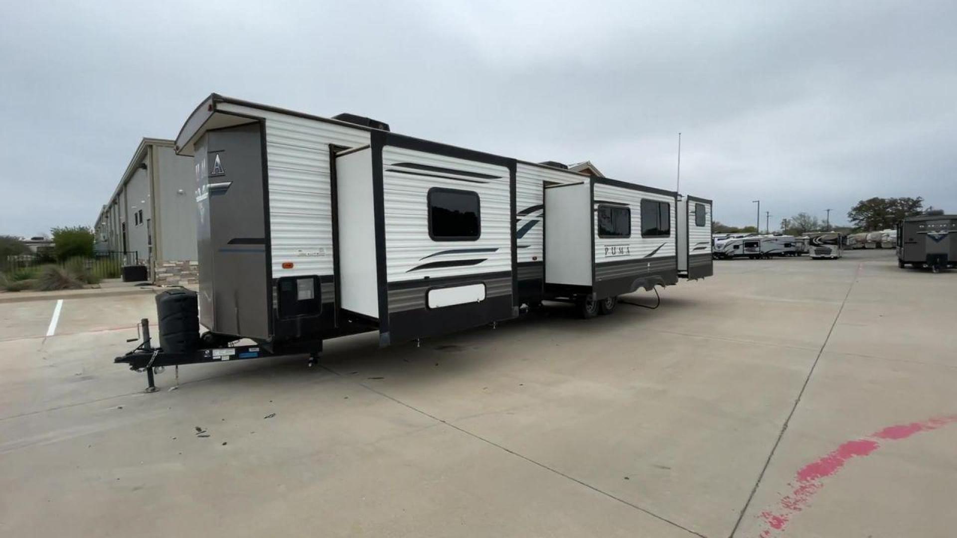 2021 TAN PUMA 39PQB - (4X4TPUR25MP) , located at 4319 N Main Street, Cleburne, TX, 76033, (817) 221-0660, 32.435829, -97.384178 - This Puma Travel Trailer measures just over 42 feet long and 8 feet wide with a dry weight of 10,709 lbs. It has a GVWR of 13,413 lbs and a hitch weight of 1,413 lbs. This unit comes with automatic heating and cooling rated at 35,000 and 13,500 BTUs respectively. The exterior of this unit is a base - Photo#5