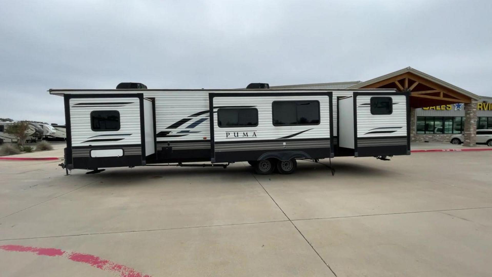 2021 TAN PUMA 39PQB - (4X4TPUR25MP) , located at 4319 N Main Street, Cleburne, TX, 76033, (817) 221-0660, 32.435829, -97.384178 - This Puma Travel Trailer measures just over 42 feet long and 8 feet wide with a dry weight of 10,709 lbs. It has a GVWR of 13,413 lbs and a hitch weight of 1,413 lbs. This unit comes with automatic heating and cooling rated at 35,000 and 13,500 BTUs respectively. The exterior of this unit is a base - Photo#6