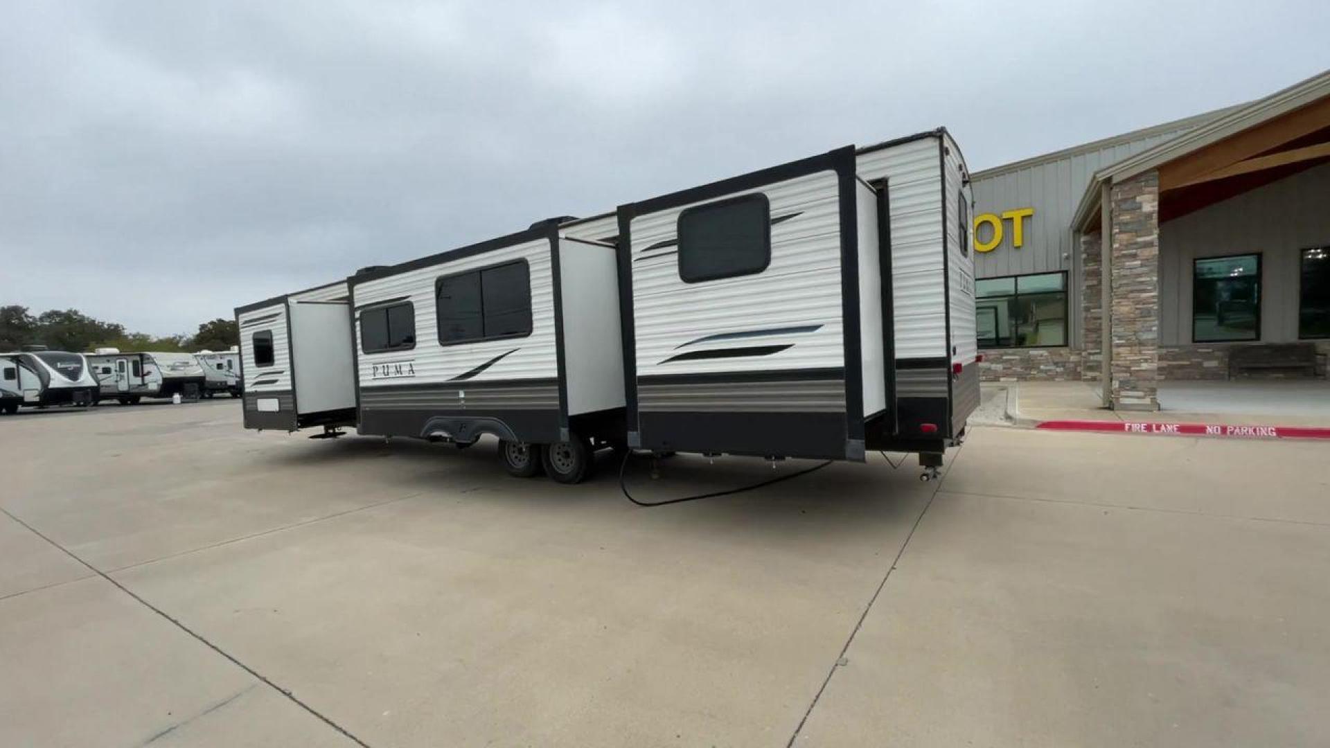 2021 TAN PUMA 39PQB - (4X4TPUR25MP) , located at 4319 N Main Street, Cleburne, TX, 76033, (817) 221-0660, 32.435829, -97.384178 - This Puma Travel Trailer measures just over 42 feet long and 8 feet wide with a dry weight of 10,709 lbs. It has a GVWR of 13,413 lbs and a hitch weight of 1,413 lbs. This unit comes with automatic heating and cooling rated at 35,000 and 13,500 BTUs respectively. The exterior of this unit is a base - Photo#7