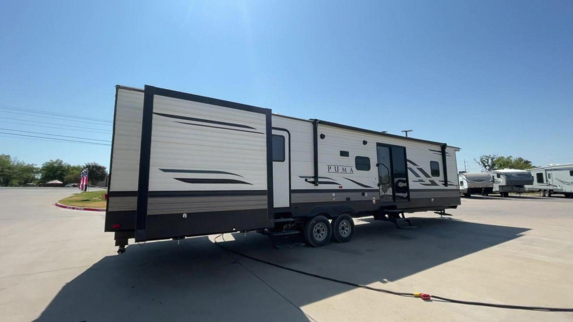 2021 PUMA 39PQB - (4X4TPUR23MP) , located at 4319 N Main Street, Cleburne, TX, 76033, (817) 221-0660, 32.435829, -97.384178 - This Puma Travel Trailer measures just over 42 feet long and 8 feet wide with a dry weight of 10,709 lbs. It has a GVWR of 13,413 lbs and a hitch weight of 1,413 lbs. This unit comes with automatic heating and cooling rated at 35,000 and 13,500 BTUs respectively. The exterior of this unit is a base - Photo#1