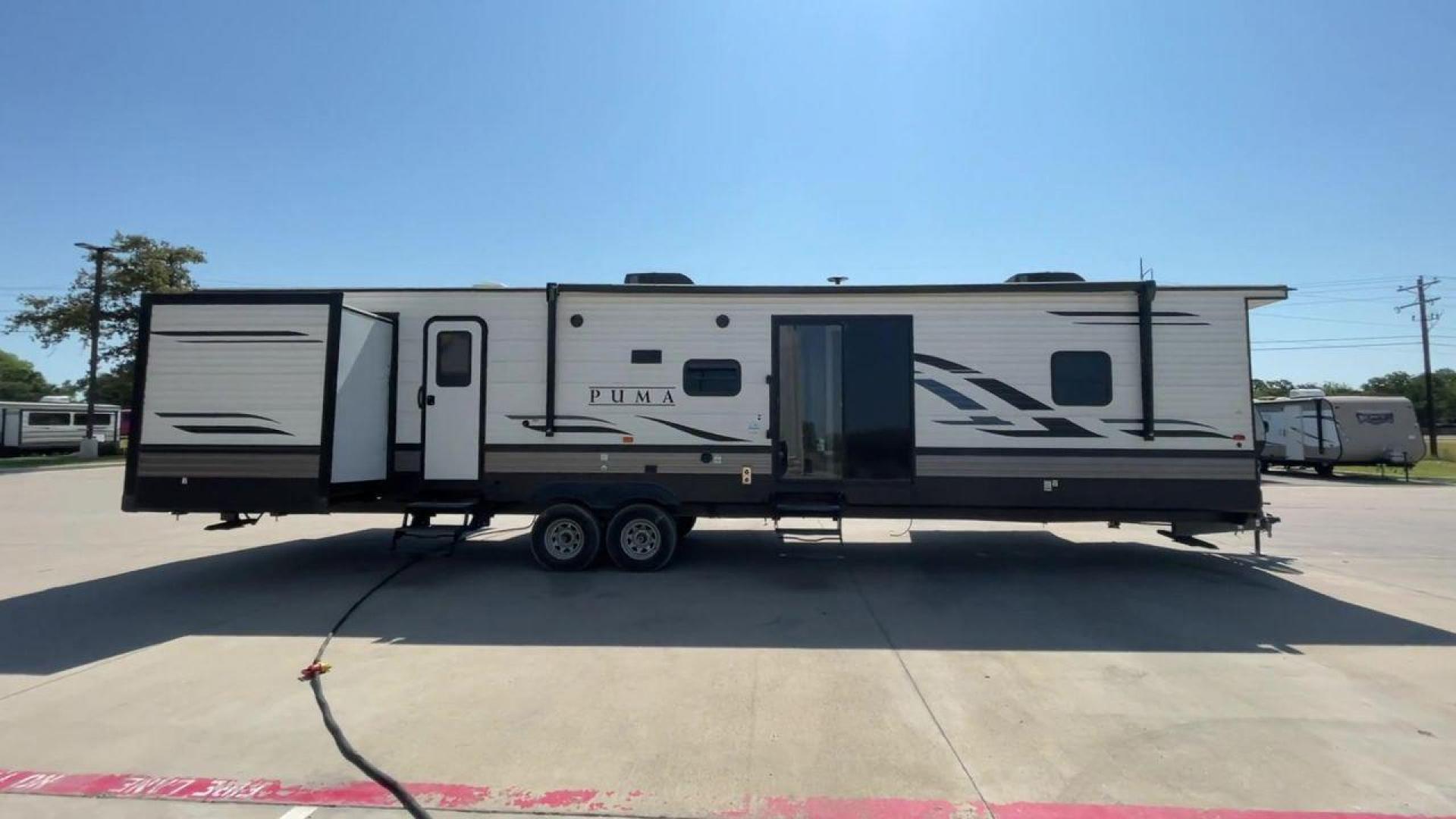 2021 PUMA 39PQB - (4X4TPUR23MP) , located at 4319 N Main Street, Cleburne, TX, 76033, (817) 221-0660, 32.435829, -97.384178 - This Puma Travel Trailer measures just over 42 feet long and 8 feet wide with a dry weight of 10,709 lbs. It has a GVWR of 13,413 lbs and a hitch weight of 1,413 lbs. This unit comes with automatic heating and cooling rated at 35,000 and 13,500 BTUs respectively. The exterior of this unit is a base - Photo#2