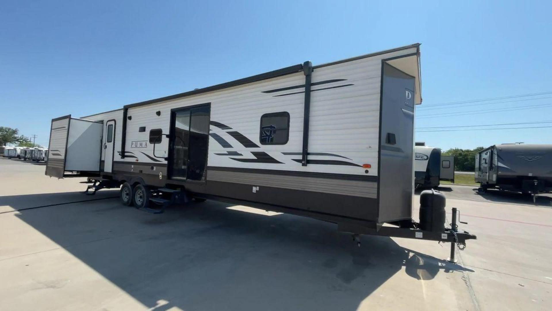 2021 PUMA 39PQB - (4X4TPUR23MP) , located at 4319 N Main Street, Cleburne, TX, 76033, (817) 221-0660, 32.435829, -97.384178 - This Puma Travel Trailer measures just over 42 feet long and 8 feet wide with a dry weight of 10,709 lbs. It has a GVWR of 13,413 lbs and a hitch weight of 1,413 lbs. This unit comes with automatic heating and cooling rated at 35,000 and 13,500 BTUs respectively. The exterior of this unit is a base - Photo#3