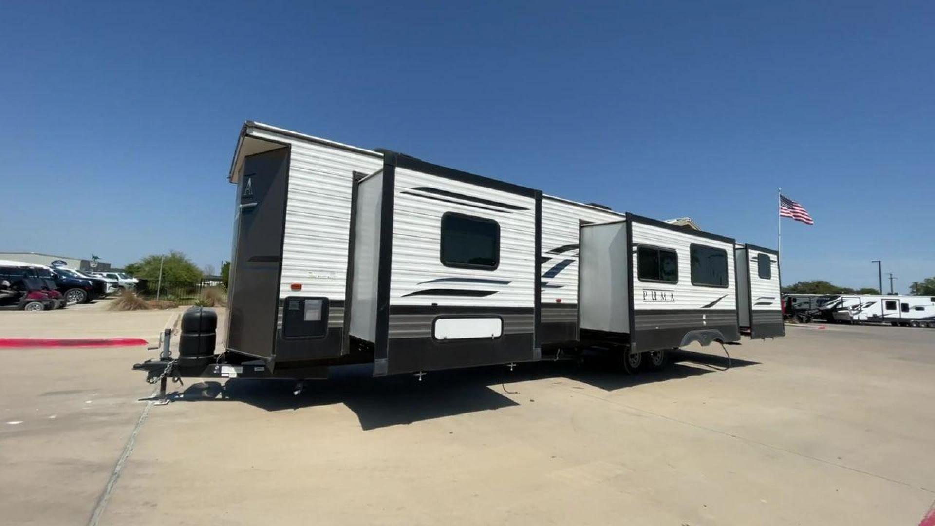 2021 PUMA 39PQB - (4X4TPUR23MP) , located at 4319 N Main Street, Cleburne, TX, 76033, (817) 221-0660, 32.435829, -97.384178 - This Puma Travel Trailer measures just over 42 feet long and 8 feet wide with a dry weight of 10,709 lbs. It has a GVWR of 13,413 lbs and a hitch weight of 1,413 lbs. This unit comes with automatic heating and cooling rated at 35,000 and 13,500 BTUs respectively. The exterior of this unit is a base - Photo#5