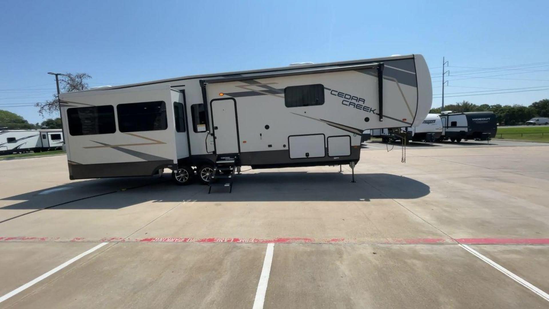 2022 FOREST RIVER CEDAR CREEK 388WDM (4X4FCRR23NS) , Length: 41.5 ft. | Dry Weight: 13,085 lbs. | Slides: 3 transmission, located at 4319 N Main Street, Cleburne, TX, 76033, (817) 221-0660, 32.435829, -97.384178 - Photo#2