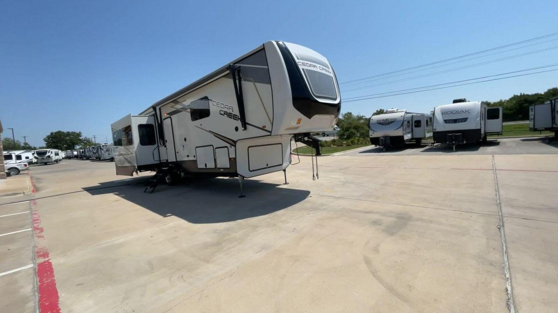 2022 FOREST RIVER CEDAR CREEK 388WDM (4X4FCRR23NS) , Length: 41.5 ft. | Dry Weight: 13,085 lbs. | Slides: 3 transmission, located at 4319 N Main Street, Cleburne, TX, 76033, (817) 221-0660, 32.435829, -97.384178 - Photo#3