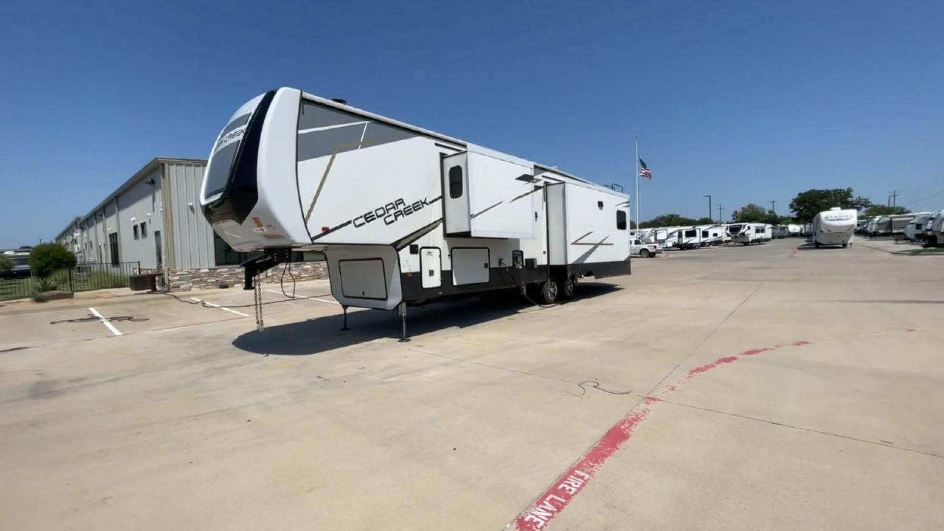 2022 FOREST RIVER CEDAR CREEK 388WDM (4X4FCRR23NS) , Length: 41.5 ft. | Dry Weight: 13,085 lbs. | Slides: 3 transmission, located at 4319 N Main Street, Cleburne, TX, 76033, (817) 221-0660, 32.435829, -97.384178 - Photo#5