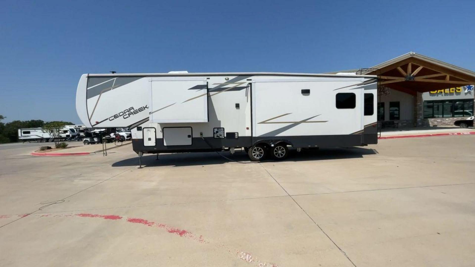 2022 FOREST RIVER CEDAR CREEK 388WDM (4X4FCRR23NS) , Length: 41.5 ft. | Dry Weight: 13,085 lbs. | Slides: 3 transmission, located at 4319 N Main Street, Cleburne, TX, 76033, (817) 221-0660, 32.435829, -97.384178 - Photo#6