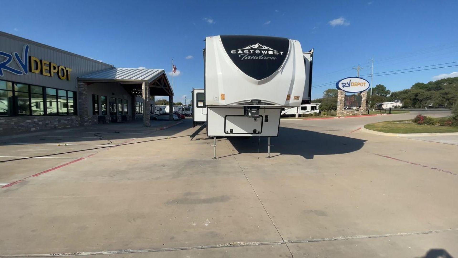 2022 FOREST RIVER EAST TO WEST TANDARA (5ZT3TD4B6N9) , Length: 41.25 ft | Dry Weight: 13,179 lbs | Slides: 4 transmission, located at 4319 N Main Street, Cleburne, TX, 76033, (817) 221-0660, 32.435829, -97.384178 - At 41.25 ft. long, the front cap showcases a bold "East to West Tandara" logo, accentuated by clean, aerodynamic curves. Large, tinted windows provide natural light while maintaining privacy. Four (4) slideouts expand the living space, enhancing functionality when parked. The trailer is equipped wit - Photo#4