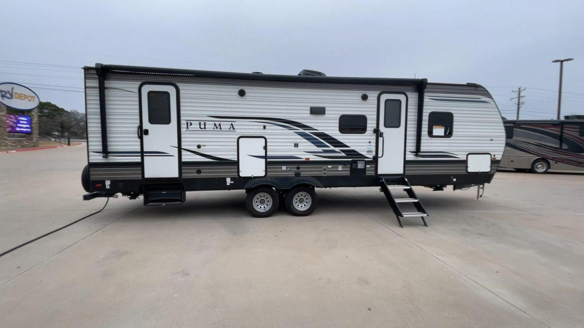 2022 FOREST RIVER PUMA 28DBFQ (5ZT2PUTB6N4) , Length: 32.83 ft | Dry Weight: 6,868 lbs | Gross Weight: 8,500 lbs | Slides: 1 transmission, located at 4319 N Main Street, Cleburne, TX, 76033, (817) 221-0660, 32.435829, -97.384178 - At 32.83 ft long, Palomino Puma 28DBFQ travel trailer boasts a sturdy and stylish design, perfect for adventure seekers. The front features a bold Puma logo with a sleek, aerodynamic shape that enhances towing efficiency. The two-tone gray and black color scheme, along with sharp graphics, gives it - Photo#2