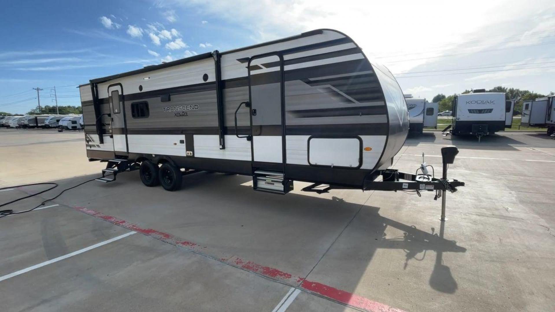 2022 GRAND DESIGN TRANSCEND 265BH (573TT3326N8) , Length: 32.75 ft. | Dry Weight: 6,327 lbs. | Gross Weight: 7,995 lbs. | Slides: 1 transmission, located at 4319 N Main Street, Cleburne, TX, 76033, (817) 221-0660, 32.435829, -97.384178 - The 2022 Grand Design Transcend 265BH is a well-designed travel trailer with a sleek black-and-gray exterior, featuring bold graphics and a modern design. This unit measures 32.75 feet in length, has a dry weight of 6,327 lbs, and a gross weight capacity of 7,995 lbs. It features one large slide-out - Photo#3