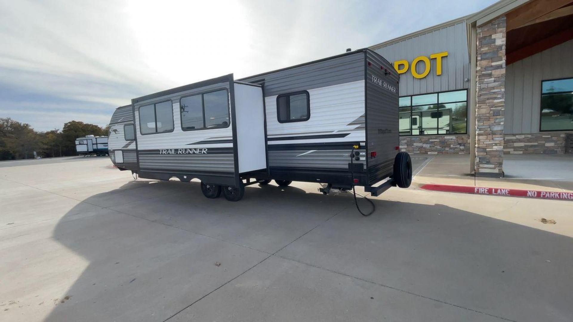 2022 HEARTLAND TRAIL RUNNER 31DB (5SFEB372XNE) , Length: 36.92 ft. | Dry Weight: 7,040 lbs. | Gross Weight: 9,642 lbs. | Slides: 1 transmission, located at 4319 N Main Street, Cleburne, TX, 76033, (817) 221-0660, 32.435829, -97.384178 - The 2022 Heartland Trail Runner 31DB has a robust and functional exterior design with modern accents. The front cap of the RV is curved for better aerodynamics, with the bold Trail Runner logo prominently displayed. The front also features a black diamond-plate guard, which offers protection from de - Photo#7